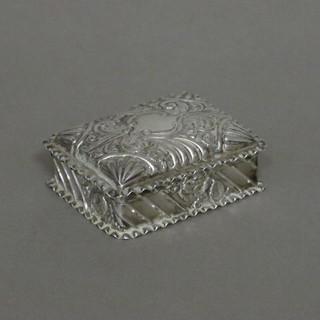 A rectangular embossed silver trinket box with hinged lid 2"
