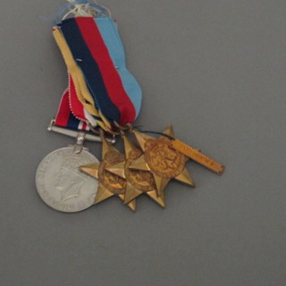 A group of 4 medals comprising 1939-45 Star, Africa Star - bar  8th Army, Italy Star and British War medal with original box