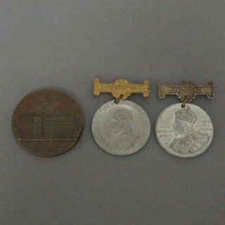 A George V School Attendance medal and a bronze medallion