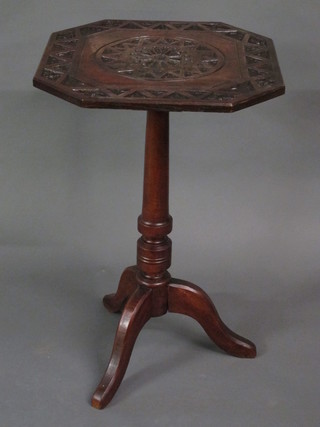 A Victorian carved oak octagonal wine table, raised on pillar and tripod supports 19"