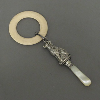 A silver rattle in the form of a dog with mother of pearl teething bar and ring, Chester - hallmarks rubbed
