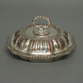 A circular silver plated entree dish and cover with gadrooned  borders