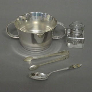 An Art Deco silver plated twin handled sugar bowl, a square inkwell with plated mounts, pair of silver sugar tongs and a silver  teaspoon