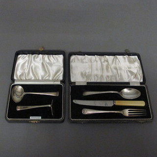 A child's silver spoon and pusher, Birmingham 1938, together  with a 3 piece christening set comprising knife, fork and spoon,  Birmingham 1941, cased