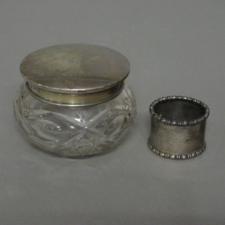 A glass dressing table jar with silver lid, Birmingham 1946 and a silver napkin ring