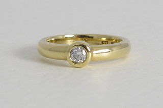 A lady's 18ct gold engagement/dress ring set a solitaire diamond