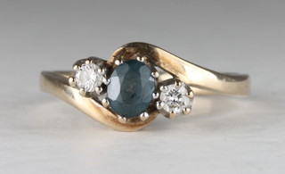 A 9ct gold dress ring set a blue stone supported by 2 white stones