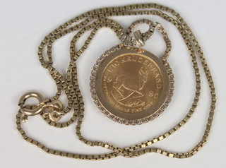 A 1980 1/10oz krugerrand, contained in a gold mount and hung on a 9ct gold chain