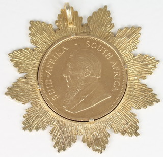 A 1975 Krugerrand contained in a gold pendant mount  ILLUSTRATED