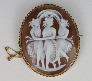 A shell carved cameo brooch decorated The Three Graces  contained in a gilt metal brooch mount