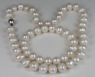 A pearl necklace and matching bracelet with silver claps