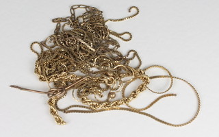 A collection of various broken gold chains