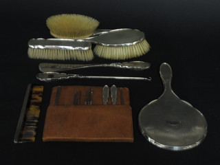 A silver backed 6 piece dressing table set comprising pair of hair brushes, hand mirror, clothes brush, comb, button hook and shoe  horn and 5 manicure implements