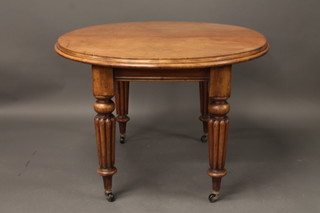 A Victorian mahogany oval extending dining table, raised on  turned and reeded supports with 1 extra leaf
