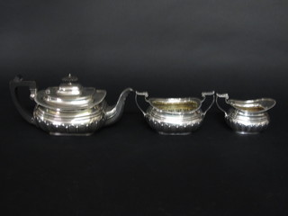 An oval silver plated 3 piece tea service with demi-reeded  decoration