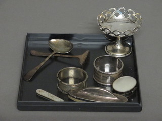 A silver pedestal bowl, 2 silver napkin rings, a silver spoon and pusher, 3 ozs, together with a manicure buffer, a silver bladed  pocket knife with mother of pearl grip and an oval trinket box