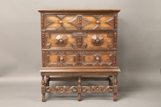A Jacobean style oak chest on stand, fitted 3 long drawers with  tore handles by Richardson of Highgate London 36"