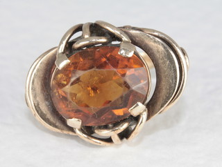 A gold dress ring set an amber coloured oval cut stone