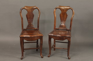 A pair of Oriental hardwood slat back hall chairs with solid seats raised on cabriole supports