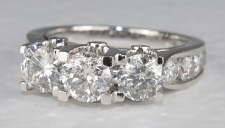 A 14ct white gold dress ring set 3 circular cut diamonds and set  8 diamonds to the shoulders, approx. 2.75ct