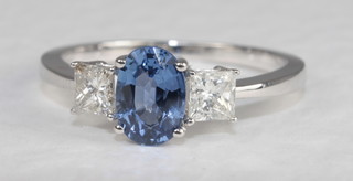 An 18ct white gold dress ring set an oval Princess cut sapphire approx 0.95ct supported by diamonds, approx. 0.47ct