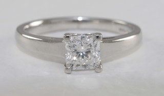 A lady's 18ct white gold solitaire dress/engagement ring set a  square cut diamond, approx 0.60ct, with certificate