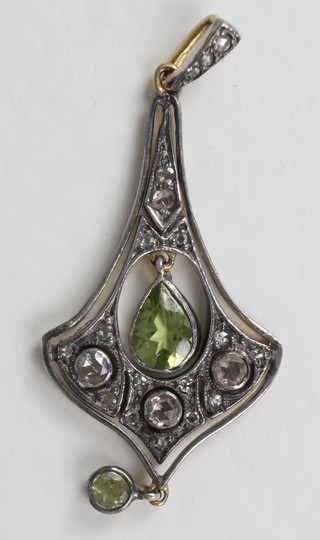 A white gold pendant set diamonds and peridot