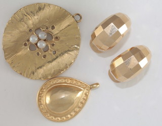 A gilt metal tear shaped pendant, a pair of gilt metal earrings and a gilt metal pendant/brooch set pearls