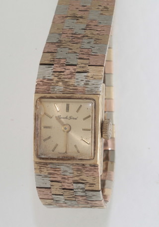 A lady's wristwatch contained in a 9ct barked gold case