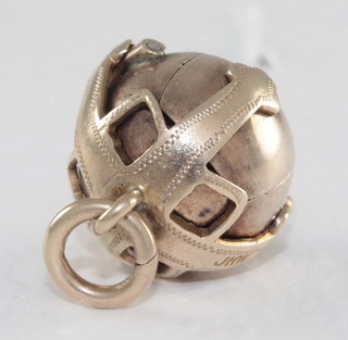 A gold Masonic ball charm