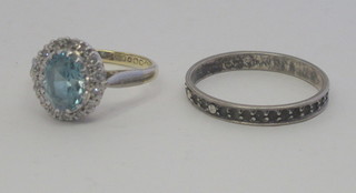 A gold dress ring set a Topaz surrounded by diamonds together  with an eternity ring