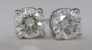 A pair of 14ct gold ear studs set diamonds, approx 1.05ct