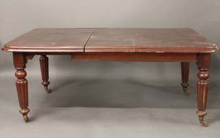A Victorian mahogany extending dining table, raised on turned  and reeded supports 67"