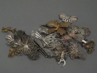 A collection of various silver filigree butterfly brooches