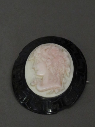 A Victorian carved "jet" and marble brooch decorated a portrait  of a lady, some chips,