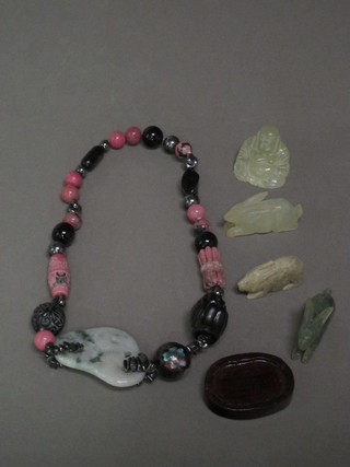 A green hardstone necklace, a hardstone figure of Buddha and 3  hardstone figures of hares