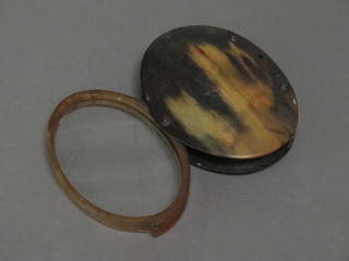 A 19th Century magnifying glass contained in a horn case