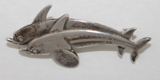 A Georg Jensen silver brooch in the form of 2 dolphins, the  reverse marked Georg Jensen, Sterling Denmark 317, complete  with original cardboard box