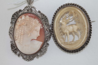 A shell carved cameo portrait brooch contained in a gilt mount  and an ivory brooch