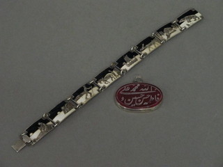 A silver and enamelled bracelet and an Eastern oval engraved  hardstone pendant in a "silver" mount