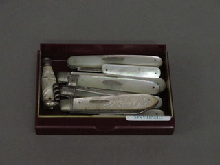 7 folding fruit knives with silver blades and mother of pearl  mounts and a small folding jack knife