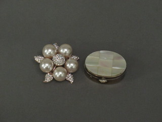 A pearl and diamonte effect brooch and an oval gilt metal pill box