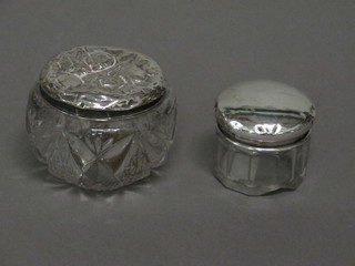 A circular glass rouge pot 2", 1 other dressing table jar with  silver lid 2"