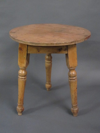 A 19th Century circular pine cricket table, raised on turned supports 27"