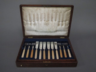A cased set of 20 fish knives and forks cased, an oak canteen box