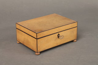 A 19th Century rectangular satinwood trinket box with hinged lid, raised on bun feet 9"