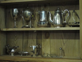 A silver plated egg boiler, a silver plated trophy cup and a collection of plated items
