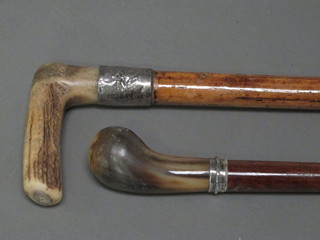 A turned walking stick with silver band and horn handle and 1  other walking stick with silver band and stag horn handle