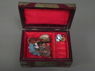 An Eastern hardwood jewellery box containing a small collection  of costume jewellery