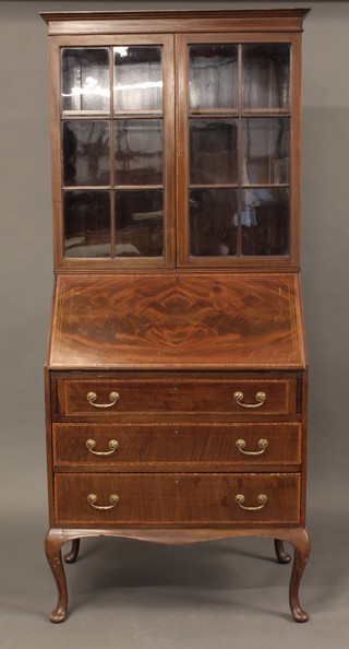 An Edwardian inlaid mahogany bureau bookcase the upper  section with moulded cornice the shelved interior enclosed by  astragal glazed panelled door, the fall front above 3 long  drawers, raised on cabriole supports 30"